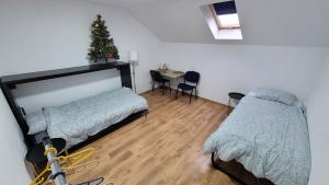 a bedroom with a christmas tree and a bed and a table at Private Room - Terasa - Gradina in Paşcani +12 photos