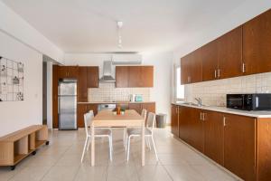 a kitchen with a table and chairs in a kitchen at Center, Walking to the Beach in Larnaka +16 photos