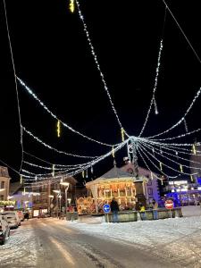 a string of lights over a street at night at La Petite Maison in Gérardmer