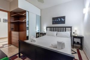 a bedroom with a large white bed with white pillows at Elegantis Purificazione Suite Apartment in Rome