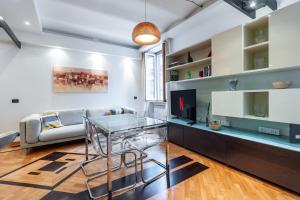 a living room with a couch and a glass table at Elegantis Purificazione Suite Apartment in Rome