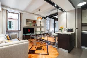a living room with a couch and a table at Elegantis Purificazione Suite Apartment in Rome