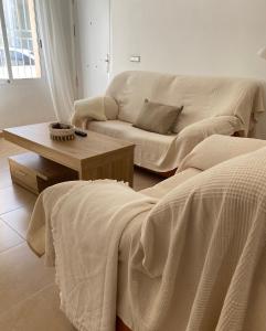 a living room with a couch and a coffee table at Bajo en Pliego - Tranquillity and Natural Beauty in Pliego