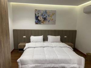 Ένα ή περισσότερα κρεβάτια σε δωμάτιο στο Nilefront Cozy Escape