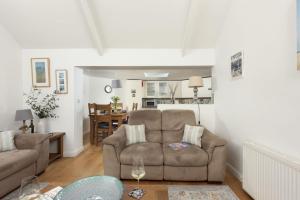 a living room with a couch and a table at Samson Cottage in Saint Mawgan +22 photos