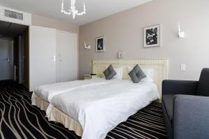 Postel nebo postele na pokoji v ubytování Hotel du Parc