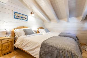 Ένα ή περισσότερα κρεβάτια σε δωμάτιο στο HelloCHALET - Piccolo Giglio Chalet