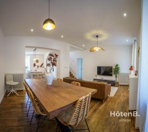 comedor y sala de estar con mesa de madera en Villa de Plaisance, en Limoges