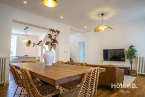 Un comedor con mesa y sillas de madera. en Villa de Plaisance, en Limoges