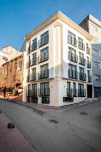 a white building on the side of a street at Urban Quarters - Firuzağa in Istanbul