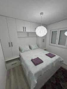 a bedroom with a bed with two towels on it at Sweet Holiday 2 in Mostar