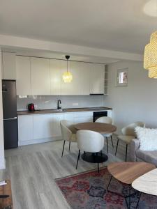 a kitchen and living room with a table and chairs at Sweet Holiday 2 in Mostar