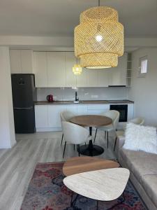 a kitchen and living room with a table and a couch at Sweet Holiday 2 in Mostar