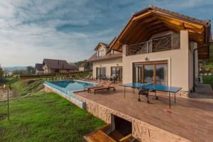 a house with a wooden deck with a pool at House Sablja in Ogulin