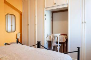 a bedroom with a bed and a table and a chair at Casa Vincy, Costa Volpino Ospitar in Costa Volpino