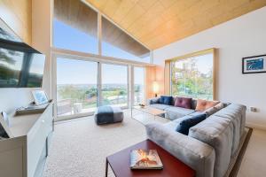 a living room with a couch and a large window at Jessamy in Wimborne Minster