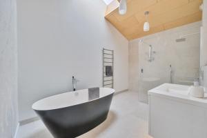 a bathroom with a black tub and a sink at Jessamy in Wimborne Minster +38 photos