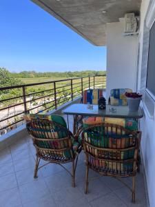 a table and two chairs sitting on a balcony at Nefeli luxury apartment in Aronás