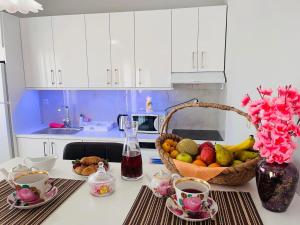 a kitchen with a basket of fruit on a counter at Nefeli luxury apartment in Aronás