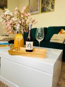 a bottle of wine and two glasses on a table at Beautiful Apartment on London Bridge! in London