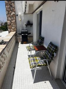 a patio with two chairs and a table on a balcony at Bar street apartment in Ayia Napa +5 photos