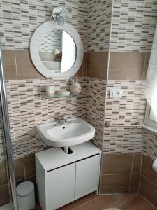 a bathroom with a sink and a mirror at Appartamento Caterina in Cairo Montenotte