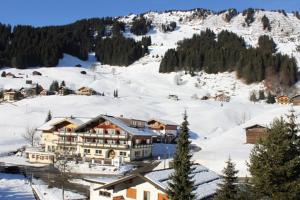 a large building on top of a snow covered mountain at App Steenbok 516 Kleinwalsertal in Mittelberg