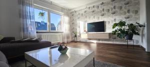 a living room with a couch and a coffee table at Ferienwohnung Ida in Xanten