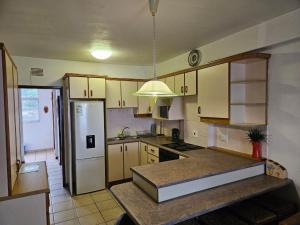 a kitchen with a refrigerator and a counter top at Margate Granada 305 in Margate