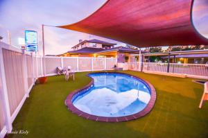a large swimming pool in the middle of a yard at Meninya Palms Resort Moama in Moama
