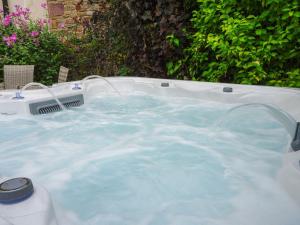 a hot tub with blue water in a backyard at The Old Bulls Head in Chapel en le Frith