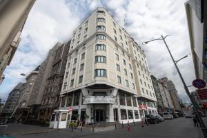 a tall white building on a city street at The Green Park Taksim in Istanbul
