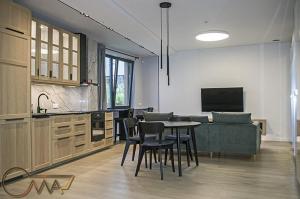 a kitchen with a table and chairs and a couch at Vilnius Old Town in Vilnius +15 photos