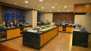 a large kitchen with counters with food on them at The Green Park Taksim in Istanbul