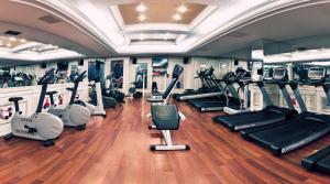 a gym with a bunch of treadmills and machines at The Green Park Taksim in Istanbul