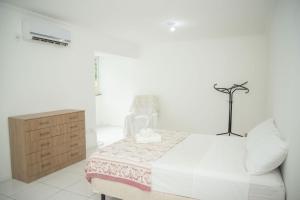 Ένα ή περισσότερα κρεβάτια σε δωμάτιο στο Conforto e Localização no Coração de POA SK1661