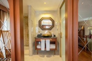 a bathroom with a vanity with a mirror and towels at The Green Park Taksim in Istanbul