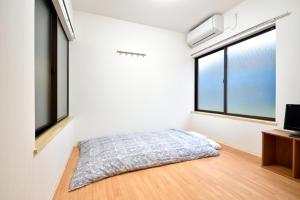 Tempat tidur dalam kamar di Senju Tamuraya