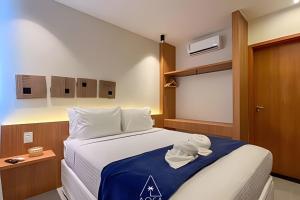 a bedroom with a large bed with a blue blanket at Flats Beira-Mar na Rota dos Milagres - Essence Tatuamunha in Pôrto de Pedras +281 photos