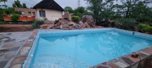a swimming pool in a yard with a house at Mmathaba Guest House in Mmadinare