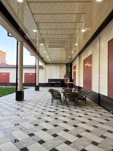 a patio with chairs and a table and a piano at Эксклюзивный Дом Самарканда in Samarkand