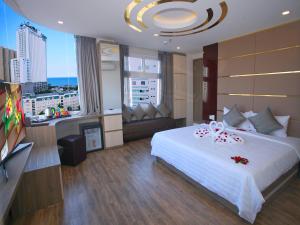
a hotel room with two beds and a table at New Sun Hotel in Nha Trang
