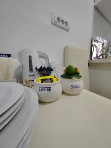 a kitchen with two bowls of food on a counter at Apartmani, New Museum Kula in Kula +16 photos