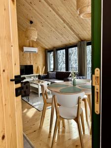 a living room with a table and chairs at High Five Villas in Pamporovo