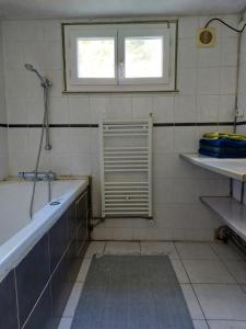 a bathroom with a bath tub and a window at Maison avec terrasse Bordeaux Chartrons in Bordeaux +6 photos