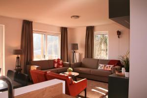 a living room with a couch and a table at UplandParcs Residence Winterberg in Winterberg