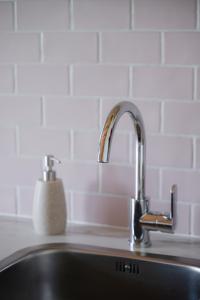 a kitchen sink with a faucet on top of it at Vakantiehuis Blok 25 in Zierikzee +25 photos