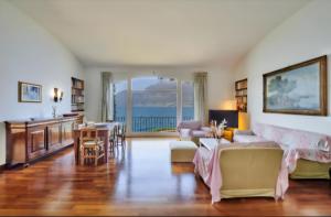 a living room with a couch and a table at On Lake Villa Cicci e Sandro in Bellano