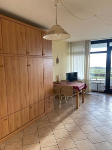 a living room with a table and a dining room at FeWo Schulze in Fehmarn