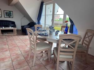 a dining room with a table and chairs at FeWo Heinz in Fehmarn +1 photo